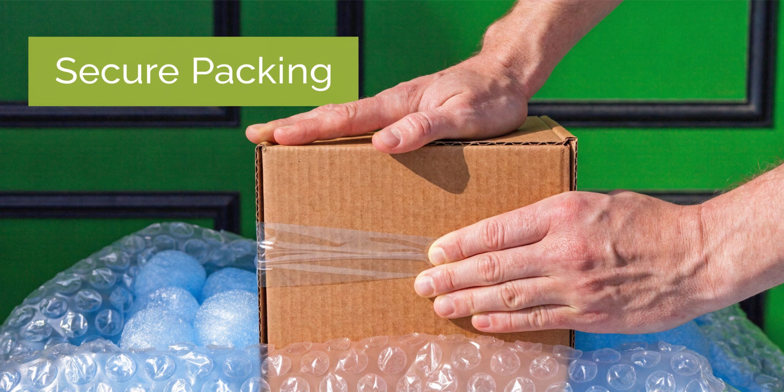 A person securely packing a cardboard box for shipping with protective bubble wrap on a green background.