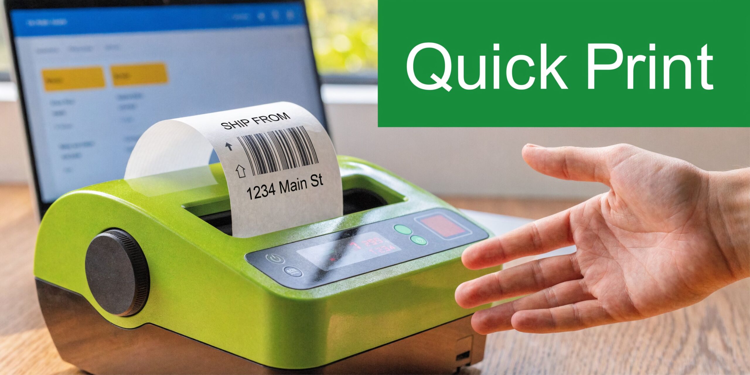 A green label printer on a desk next to a person's hand holding a printed shipping label.