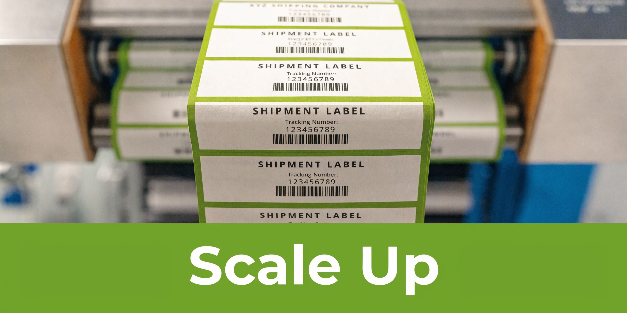 A close-up view of an industrial printer producing a continuous roll of identical green shipment labels.