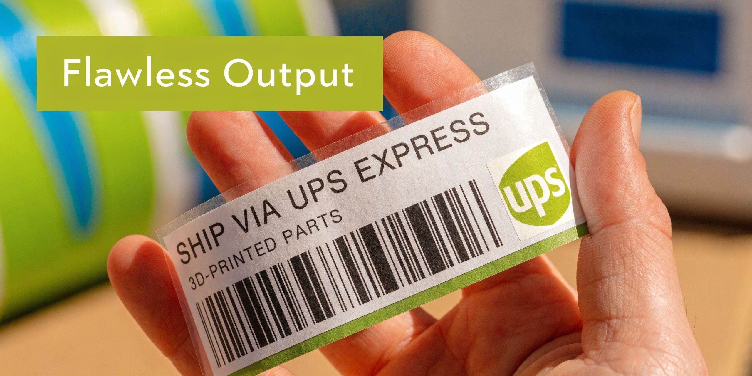 A hand holds a transparent shipping label with UPS Express text and a barcode printed on it.
